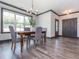 Bright dining room features a wooden table with chairs, hardwood floors, a chandelier, and natural light at 335 Glenn St, Franklinton, NC 27525