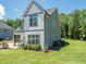 A two-story home with a well-maintained lawn and landscaping, offering a serene suburban setting with trees around it at 335 Glenn St, Franklinton, NC 27525