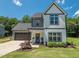 Two-story home with a well-manicured lawn, attached garage, and a welcoming front porch and tidy landscaping at 335 Glenn St, Franklinton, NC 27525