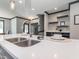 Modern kitchen with an island sink, quartz countertop, and view of the stylish wine rack and dining space at 335 Glenn St, Franklinton, NC 27525