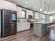 Modern kitchen featuring white cabinets, stainless steel refrigerator, and spacious island at 335 Glenn St, Franklinton, NC 27525