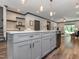 Kitchen island with bar seating, stainless steel dishwasher, and open-concept living space at 335 Glenn St, Franklinton, NC 27525