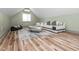 Attic living room with hardwood floors, a modern sofa, and contemporary furniture at 335 Glenn St, Franklinton, NC 27525