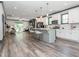 Open-concept living area with kitchen island, wood flooring, and sliding glass door to patio at 335 Glenn St, Franklinton, NC 27525