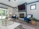 Cozy living room with a fireplace, TV, stylish seating, hardwood floors, and a bright view outside at 335 Glenn St, Franklinton, NC 27525