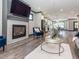 Spacious living room with fireplace, TV, modern decor, hardwood floors, and an open layout into the kitchen at 335 Glenn St, Franklinton, NC 27525