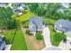 An aerial view of a single Gathering home with landscaped lawn and mature trees at 3504 Regent Pines Dr, New Hill, NC 27562