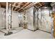 Unfinished basement featuring exposed pipes and a door at 3504 Regent Pines Dr, New Hill, NC 27562