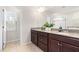 Bathroom with double sinks, granite countertops, and a large mirror at 3504 Regent Pines Dr, New Hill, NC 27562