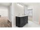 Modern bathroom with dual sink vanity and white tile flooring, leading to a bedroom at 3504 Regent Pines Dr, New Hill, NC 27562