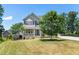 Charming two-story home featuring a manicured lawn and inviting front porch, perfect for suburban living at 3504 Regent Pines Dr, New Hill, NC 27562