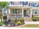 Inviting front porch featuring stone accents and a cozy seating area, enhancing curb appeal at 3504 Regent Pines Dr, New Hill, NC 27562