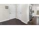 Hallway with dark hardwood floors and stainless steel refrigerator at 3504 Regent Pines Dr, New Hill, NC 27562