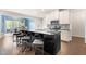 Open-concept kitchen featuring a large island with seating and modern appliances at 3504 Regent Pines Dr, New Hill, NC 27562
