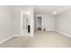 Open floor plan with neutral carpeting leading to a bathroom and bedroom at 3504 Regent Pines Dr, New Hill, NC 27562