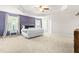 Spacious main bedroom boasts tray ceiling, natural light, and neutral carpet at 3504 Regent Pines Dr, New Hill, NC 27562