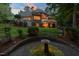 Exterior view of the back of the house with a well-manicured lawn, water feature, and patio at 3606 Dairy Pond Pl, Durham, NC 27705