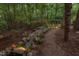 Beautiful backyard with tranquil creek, landscaping and mature trees creating a private oasis at 3606 Dairy Pond Pl, Durham, NC 27705