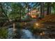 Home's backyard features a charming water feature, mature trees and multi-level patio at 3606 Dairy Pond Pl, Durham, NC 27705