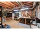 Unfinished basement featuring a workshop area with pegboard, workbench, storage, and exposed ceiling insulation at 3606 Dairy Pond Pl, Durham, NC 27705