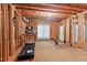 Unfinished basement featuring a treadmill, exercise bike and exposed wooden framing at 3606 Dairy Pond Pl, Durham, NC 27705