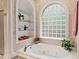 Elegant bathroom with a soaking tub and a unique glass block window at 3606 Dairy Pond Pl, Durham, NC 27705