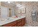Bathroom featuring double sinks, and decorative wallpaper at 3606 Dairy Pond Pl, Durham, NC 27705