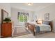 Bedroom with two beds, rug, and window at 3606 Dairy Pond Pl, Durham, NC 27705