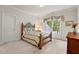 Comfortable bedroom with a decorative bed frame, soft carpet, and large window with backyard view at 3606 Dairy Pond Pl, Durham, NC 27705