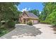Charming brick home with manicured landscaping, a circular driveway, and a three-car garage at 3606 Dairy Pond Pl, Durham, NC 27705