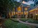 Charming two-story brick home with manicured front yard and inviting entryway at twilight at 3606 Dairy Pond Pl, Durham, NC 27705
