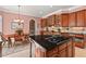 Updated kitchen boasts wood cabinets, granite counters, stainless steel appliances, and adjacent dining area at 3606 Dairy Pond Pl, Durham, NC 27705