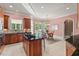 Spacious kitchen with wood cabinets, center island, granite countertops, and a dining area at 3606 Dairy Pond Pl, Durham, NC 27705