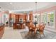 Bright kitchen with a center island, granite counters, stainless steel appliances, and adjacent dining area at 3606 Dairy Pond Pl, Durham, NC 27705