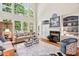Spacious living room featuring high ceilings, fireplace, large windows, and hardwood floors at 3606 Dairy Pond Pl, Durham, NC 27705