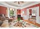 Comfortable living room featuring hardwood floors, large windows, tray ceilings, and an adjacent study at 3606 Dairy Pond Pl, Durham, NC 27705