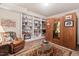 Basement sitting area with built-in shelving and a decorative wood-paneled wine storage unit for the discerning collector at 3606 Dairy Pond Pl, Durham, NC 27705