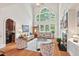 Bright living room with soaring ceilings, fireplace, large windows, and hardwood floors at 3606 Dairy Pond Pl, Durham, NC 27705
