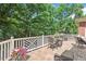Inviting outdoor living area with a tiled floor, white railings, and comfortable seating arrangements at 3606 Dairy Pond Pl, Durham, NC 27705