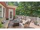 Outdoor patio with a cozy seating area, a fire pit, and views of the landscaped yard at 3606 Dairy Pond Pl, Durham, NC 27705