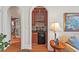 Living room wet bar featuring custom cabinetry, granite countertop, and beverage refrigerator at 3606 Dairy Pond Pl, Durham, NC 27705