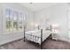 Bright bedroom features neutral carpet, plantation shutters, and matching bedside lamps at 408 Brierley Dr, Apex, NC 27523