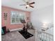 Bright bedroom with workout space, featuring a Peloton bike near a window with plantation shutters at 408 Brierley Dr, Apex, NC 27523