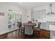 Cozy breakfast nook with hardwood floors, built-in cabinets, shutters, and abundant natural light at 408 Brierley Dr, Apex, NC 27523