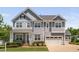 Charming two-story home with a well-maintained lawn, attached garage, and inviting curb appeal at 408 Brierley Dr, Apex, NC 27523