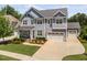 Charming two-story home with a well-manicured lawn and a spacious three-car garage at 408 Brierley Dr, Apex, NC 27523