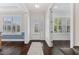 Bright foyer with hardwood floors, white trim, natural light, and stylish rug at 408 Brierley Dr, Apex, NC 27523