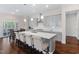 Bright, open kitchen features a large island with seating, pendant lights, and stainless steel appliances at 408 Brierley Dr, Apex, NC 27523