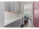 Transitional kitchen featuring white countertops, gray cabinets, stainless steel appliances, and hardwood floors at 408 Brierley Dr, Apex, NC 27523