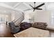 Living room showcasing staircase, plush seating, hardwood floors, and large window with plantation shutters at 408 Brierley Dr, Apex, NC 27523